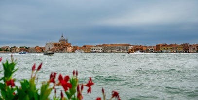 Famous buildings, gondolas and monuments by the Rialto Bridge of Venice on the Grand Canal, Italy.