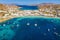 Photo of aerial view to the popular bay of Ornos on the island of Mykonos, Greece.