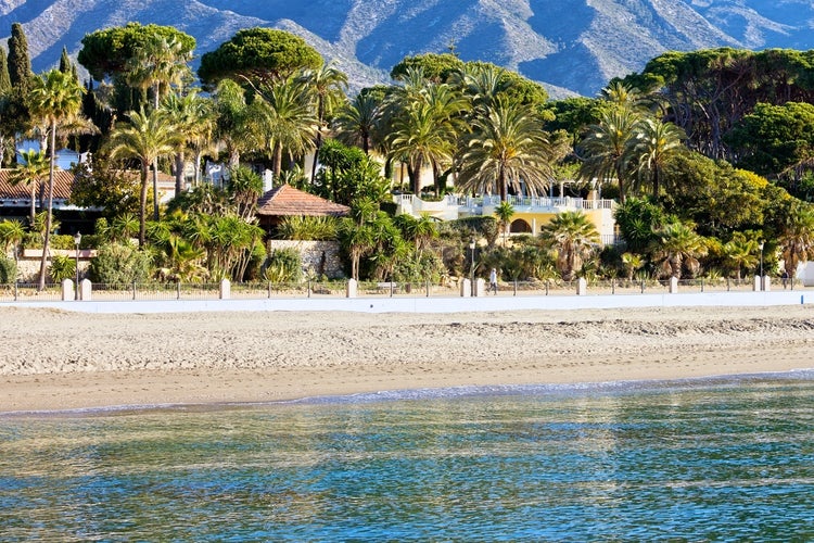 Marbella sandy beach coastline summer holiday scenery by the Mediterranean Sea in Spain, Andalusia region, Costa del Sol, Malaga province.