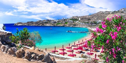 Photo of panoramic aerial view of the popular Platis Gialos beach on the Greek island of Mykonos with turquoise sea, Greece.