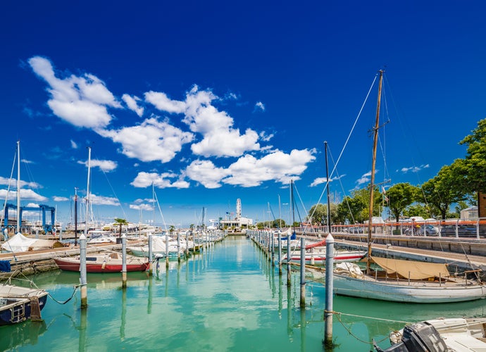 Photo of Scenic spring view of pier with ancient and modern buildings, ships, yachts and other boats in Rimini, Italy.