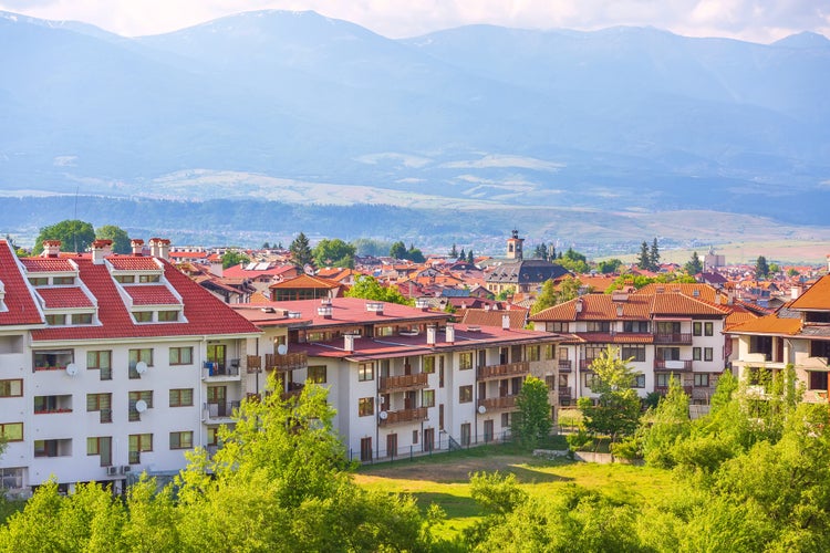 Photo of Bansko, Bulgaria summer town panorama of bulgarian ski resort with Rila mountain peaks and church tower.