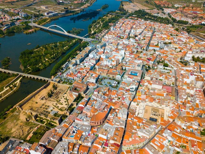 photo of view of Scenic aerial view of Spanish city of Merida with ancient Roman Bridge and modern Lusitania Bridge over Guadiana river