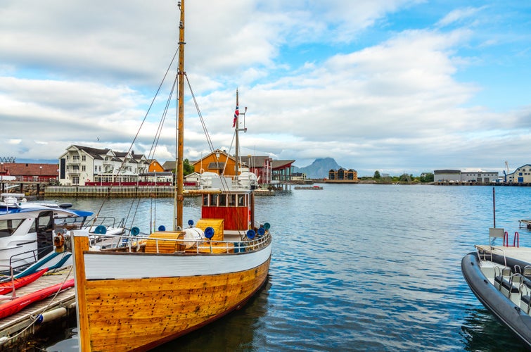 Yachts and boats with lagoon in the background at pier in Svolvaer, Lofoten islands, Austvagoya, Vagan Municipality, Nordland County, Norway.