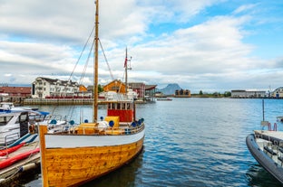 Photo of houses, bridge and panorama of Norwegian city Tromso beyond the Arctic circle from mountain in Norwegian fjords.