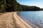 photo of Tiveden Nationalpark Sweden. Vitsand trehorningen lake. Sandy shore on a sunny spring day.