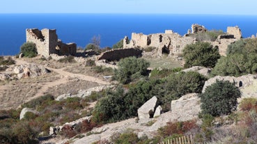 Photo of aerial view from the walls of the citadel of Calvi on the old town with historic buildings and bay with yachts and boats, Corsica, France.