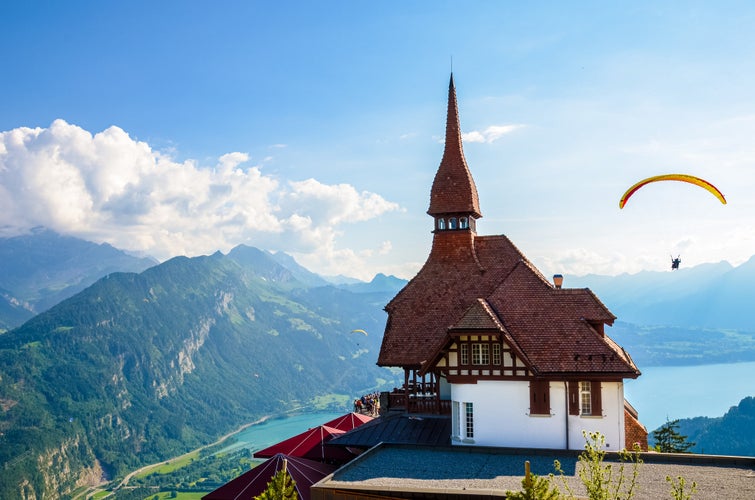 Photo of Stunning view of the top of Harder Kulm in Interlaken, Switzerland photographed in summer with paragliders flying around.