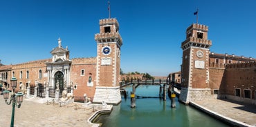 Famous buildings, gondolas and monuments by the Rialto Bridge of Venice on the Grand Canal, Italy.