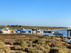 Photo of aerial cityscape of beautiful Tavira with roman bridge over Gilao river in the evening, Algarve, Portugal.