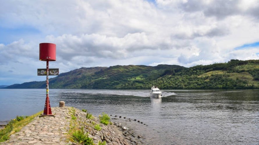 A boat cruising on the calm waters of Loch Ness.jpg