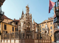 Photo of aerial view of Verona historical city centre, Ponte Pietra bridge across Adige river, Verona Cathedral, Duomo di Verona, red tiled roofs, Veneto Region, Italy.