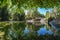 Photo of the artificial lake with the wooden bridge at the National Garden of Athens, Greece.