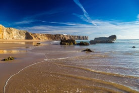 Photo of aerial view of beautiful lighthouse located on high cliffs of Saint Vincent cape in Sagres, Algarve, Portugal.