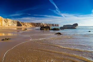 Photo of aerial view of beautiful lighthouse located on high cliffs of Saint Vincent cape in Sagres, Algarve, Portugal.