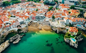 Photo of aerial view over People Crowd Having Fun On Beach And Over Cascais City In Portugal.