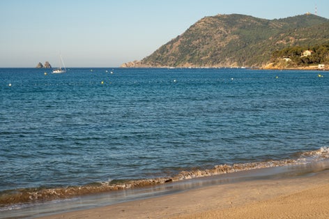 Photo of white sandy beach Les Sablettes in La Seyne-Sur-Mer in morning sunlight, France.