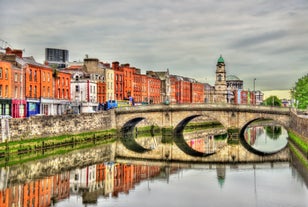 Aerial view of Dublin city center at sunset with River Liffey and Samuel Beckett bridge in the middle. Bridge designed by Santiago Calatrava.