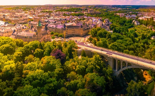 photo of panoramic aerial view of adolph bridge, Fort burbon and musee de la banque in luxembourg on a beautiful summer day, Luxembourg.