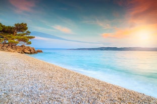 Photo of panorama and landscape of Makarska resort and its harbour with boats and blue sea water, Croatia.