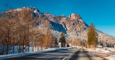 photo of Elevated, scenic view of the town of Bischofswiesen, Bavaria, Germany. The Watzmann Mountain, part of the Bavarian Alps rises into a majestic skyline. A green, spring landscape set in the valley.