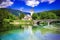 Bohinj Lake, Slovenia. Church of St John the Baptist with bridge over Sava River. Triglav National Park in Julian Alps.