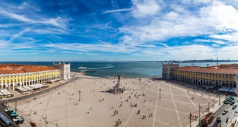 Photo of aerial view over People Crowd Having Fun On Beach And Over Cascais City In Portugal.