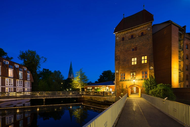 Photo of Bridge and old tower at the Ilmenau River in the old town of Lueneburg, Germany 