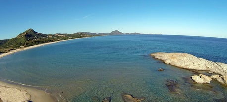 Photo of aerial view of a beautiful bay with azure sea from top of a hill, Villasimius, Sardinia island, Italy.