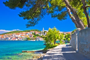 Photo of panorama and landscape of Makarska resort and its harbour with boats and blue sea water, Croatia.