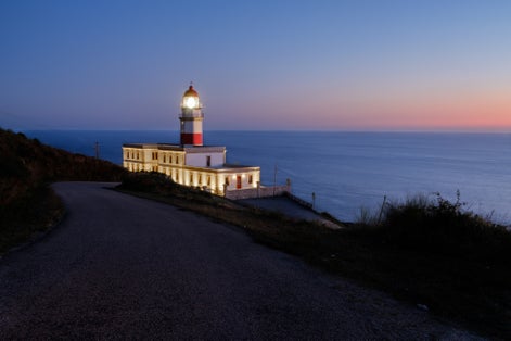 photo of Cabo Silleiro lighthouse on the Atlantic coast of Galicia at sunset in Baiona, Spain.