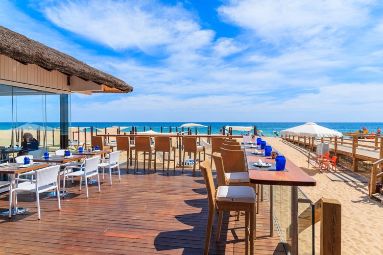 Photo of terrace of a restaurant on Armacao de Pera beach in Algarve region, Portugal.