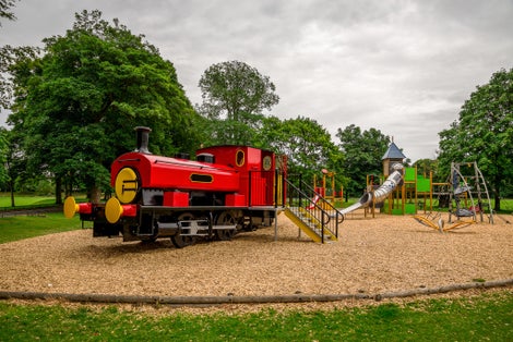 Photo of Large red train in Seaton park outdoor children playground, Aberdeen city, Scotland .