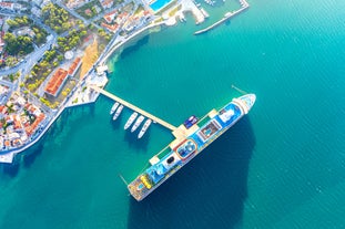 Photo of white boat in crystal clear blue sea water, Argostoli, Greece.