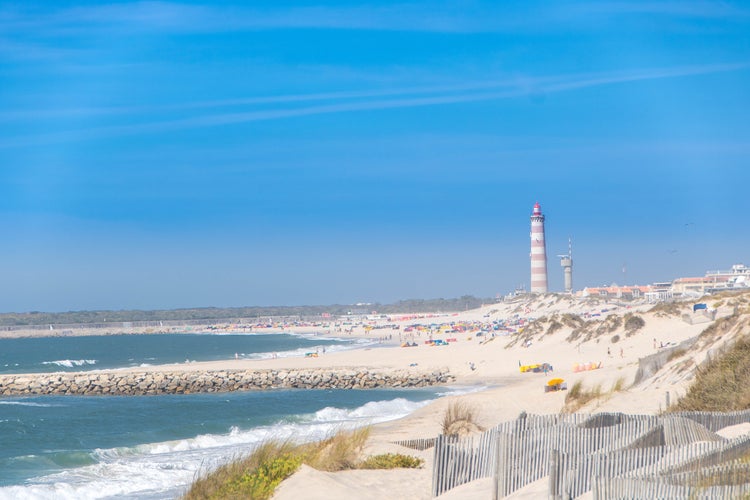 The beach of Costa Nova do Prado at Aveiro, and the Lighthouse of Praia da Barra on the Atlantico coast of Portugal