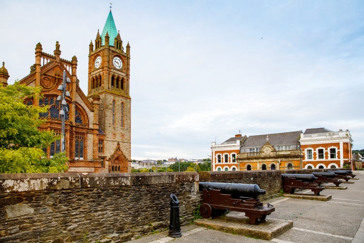 photo of view of Derry, North Ireland. Aerial view of Derry Londonderry city center in Northern Ireland, UK. Sunny day with cloudy sky, city walls and historical buildings.