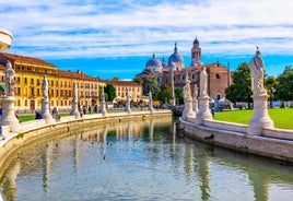 Photo of beautiful view of canal with statues on square Prato della Valle and Basilica Santa Giustina in Padova (Padua), Veneto, Italy.