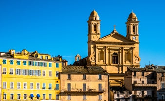 Photo of colorful houses on the shore of Bastia port, bright morning view of Corsica island, France.