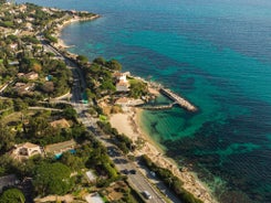 Photo of beautiful aerial view of Saint-Tropez, France with seascape and blue sky.