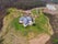 photo of aerial view of the Jurassic Museum in the shape of a dinosaur footprint in Colunga, Asturias. Spain.