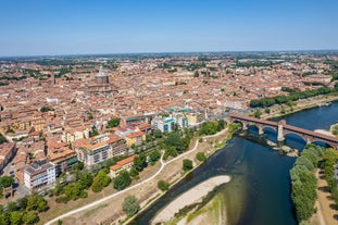 Photo of aerial view of Pavia and the Ticino, Cathedral of Pavia and Covered Bridge, Italy.