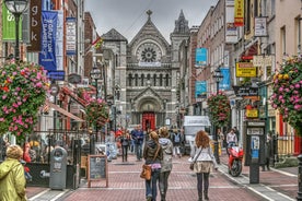 Photo of Colorful row houses with towering cathedral in background in the port town of Cobh, County Cork, Ireland.