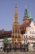 Photo of scenic summer view of the German traditional medieval half-timbered Old Town architecture and bridge over Pegnitz river in Nuremberg, Germany.