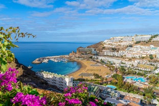 photo of landscape with Maspalomas town and golden sand dunes at sunrise, Gran Canaria, Canary Islands, Spain.