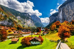 Photo of beautiful autumn view of Lauterbrunnen valley with gorgeous Staubbach waterfall and Swiss Alps at sunset time, Switzerland.