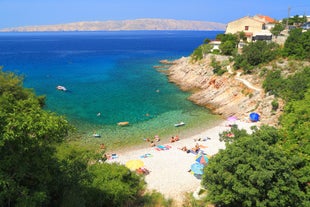 photo of  Pláž Senj it's a small beach hidden by vegetation near the Adriatic Sea, Senj, Croatia.