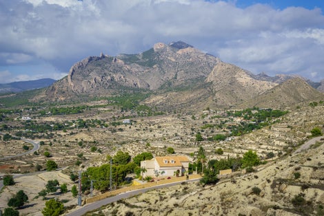 photo of Cabezon de Oro or Big Golden Head Mountain and Canelobre Caves entrance in Busot, Spain.