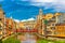 Photo of colorful yellow and orange houses and Eiffel Bridge, Old fish stalls, reflected in water river Onyar, in Girona, Catalonia, Spain.