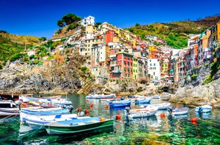 Photo of Riomaggiore with colorful houses along the coastline, one of the five famous coastal village in the Cinque Terre National Park, Liguria, Italy.