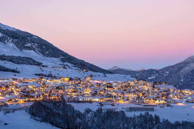 photo of view of Sunset over Austrian village Fiss in winter in the snow.